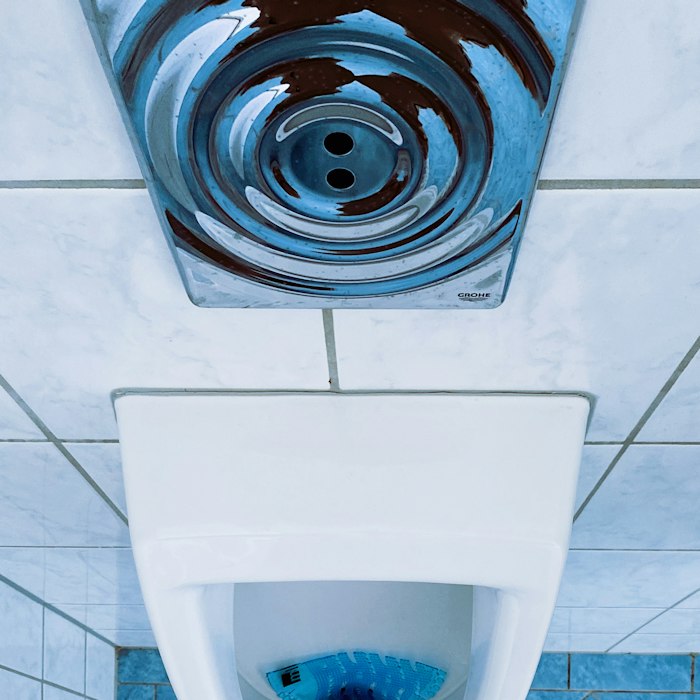 Plumber clearing a blocked toilet in Southport
