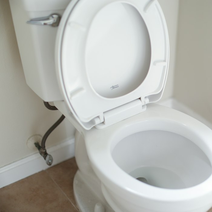 Plumber replacing a toilet fill valve